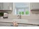 Close up of the kitchen sink and window with green leafy trees outside at 137 Burton Hills Cir, Gastonia, NC 28054