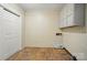 This laundry room has tile floors, white cabinets and easy access to hookups for laundry machines at 137 Burton Hills Cir, Gastonia, NC 28054
