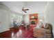 Bright living room featuring a brick fireplace, hardwood flooring, and comfortable seating at 137 Burton Hills Cir, Gastonia, NC 28054