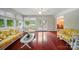 Bright sunroom with hardwood floors, wicker furniture, and French doors to the outside at 137 Burton Hills Cir, Gastonia, NC 28054