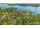 Beautiful community aerial view with lake access, a swimming pool, and lush green trees at 13932 Queens Harbor Rd, Charlotte, NC 28278
