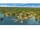 Stunning aerial view of lakefront property with private boat docks and lush green surroundings at 13932 Queens Harbor Rd, Charlotte, NC 28278
