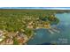 Aerial view of community nestled by a large lake with private boat docks creating a serene and inviting place to live at 13932 Queens Harbor Rd, Charlotte, NC 28278
