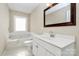 Bathroom featuring a soaking tub, vanity, and toilet at 13932 Queens Harbor Rd, Charlotte, NC 28278