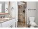 Bathroom featuring tiled walk-in shower, granite vanity, and modern fixtures at 13932 Queens Harbor Rd, Charlotte, NC 28278