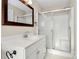 Well-maintained bathroom featuring a glass-enclosed shower, white vanity, and ample lighting for a spa-like feel at 13932 Queens Harbor Rd, Charlotte, NC 28278