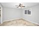 Neutral bedroom with tile flooring, a ceiling fan, and a window offering natural light, enhancing its appeal at 13932 Queens Harbor Rd, Charlotte, NC 28278