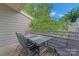 Outdoor deck area with a patio table set and lush tree views at 13932 Queens Harbor Rd, Charlotte, NC 28278