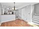 Open-concept dining area with hardwood floors and staircase access at 13932 Queens Harbor Rd, Charlotte, NC 28278