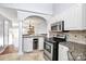 Kitchen with granite countertops, stainless appliances, and decorative backsplash at 13932 Queens Harbor Rd, Charlotte, NC 28278