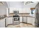 Updated kitchen with stainless steel appliances, granite counters, and designer backsplash at 13932 Queens Harbor Rd, Charlotte, NC 28278
