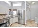 Modern kitchen with stainless steel refrigerator, granite countertops, and ample cabinet space at 13932 Queens Harbor Rd, Charlotte, NC 28278