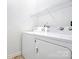 Practical laundry room equipped with washer, dryer, and shelving at 13932 Queens Harbor Rd, Charlotte, NC 28278