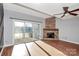 Bright living room featuring a stone fireplace, hardwood floors, and glass doors at 13932 Queens Harbor Rd, Charlotte, NC 28278