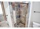 Close up of tiled shower featuring mosaic floors and stone walls at 13932 Queens Harbor Rd, Charlotte, NC 28278