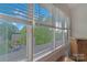 Bright window with white blinds showcasing a view of lush trees and blue sky, offering a serene ambiance at 13932 Queens Harbor Rd, Charlotte, NC 28278