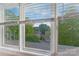 Bright window view overlooking rooftops and verdant trees under a clear blue sky, creating a serene ambiance at 13932 Queens Harbor Rd, Charlotte, NC 28278