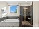 Luxurious bathroom with a soaking tub, separate shower, and elegant fixtures at 149 Glenn Dr, Mooresville, NC 28115