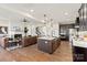 Spacious open-concept kitchen with island, seamlessly flowing into the living area with a fireplace at 149 Glenn Dr, Mooresville, NC 28115