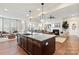 Open-concept kitchen with a large island flowing into a living room with a fireplace, great for entertaining at 149 Glenn Dr, Mooresville, NC 28115
