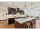 Beautiful kitchen featuring a large island, stainless steel appliances, dark cabinets, and pendant lighting at 149 Glenn Dr, Mooresville, NC 28115