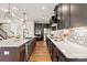 Modern kitchen with stainless steel appliances, dark cabinets, white countertops, and a stylish backsplash at 149 Glenn Dr, Mooresville, NC 28115