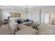 Relaxing living room offers a large sectional, modern lighting, and stylish decor at 149 Glenn Dr, Mooresville, NC 28115