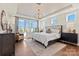 Luxurious bedroom featuring a tray ceiling, chandelier, and large window with natural light at 149 Glenn Dr, Mooresville, NC 28115