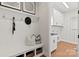 Bright mudroom featuring a built-in bench, coat hooks, and convenient access to the laundry room at 149 Glenn Dr, Mooresville, NC 28115