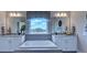 Luxurious primary bathroom features dual sinks, white cabinets, soaking tub with stunning view of the neighborhood at 153 Glenn Dr, Mooresville, NC 28115