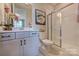 Bathroom with granite counters, neutral walls, tile floors, glass enclosed shower, toilet and flower arrangement at 153 Glenn Dr, Mooresville, NC 28115