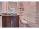 Full pink bathroom featuring a dark vanity with double sinks, a shower-tub combo and flamingo wallpaper at 153 Glenn Dr, Mooresville, NC 28115