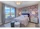 Stylized bedroom with large windows providing natural light, complemented by trendy wallpaper and modern furniture at 153 Glenn Dr, Mooresville, NC 28115