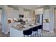 Modern kitchen featuring an island, stainless steel appliances, granite countertops, and white cabinetry at 153 Glenn Dr, Mooresville, NC 28115