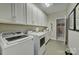 Well-equipped laundry room with modern washer, dryer, and ample storage ensures efficient chore management at 153 Glenn Dr, Mooresville, NC 28115