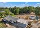 Expansive property featuring a cozy one-story home, carport, outbuilding and a partially cleared lot surrounded by trees at 159 Old Home Pl, China Grove, NC 28023