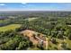 Stunning aerial view of farm with surrounding lush forest at 159 Old Home Pl, China Grove, NC 28023