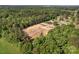An aerial view shows the vacant lot is surrounded by mature trees at 159 Old Home Pl, China Grove, NC 28023