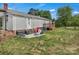 This backyard offers a small wooden deck and ample green space for outdoor activities at 159 Old Home Pl, China Grove, NC 28023
