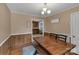 A dining room with seating for six, wood floors, and wood paneling on the lower part of the walls at 159 Old Home Pl, China Grove, NC 28023