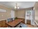 An inside dining room with a chandelier, wood table and seat, wood floors, and paneling along the wall at 159 Old Home Pl, China Grove, NC 28023