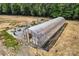 Aerial view of a greenhouse showcasing rows of shelving at 159 Old Home Pl, China Grove, NC 28023