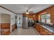 Functional kitchen features wood cabinets, stainless steel appliances and tiled floor at 159 Old Home Pl, China Grove, NC 28023
