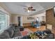 A living room with wood floors, a couch, and views into other rooms at 159 Old Home Pl, China Grove, NC 28023