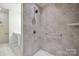 Tiled walk-in shower with grab bars in a modern bathroom at 16112 Lakeside Loop Ln, Cornelius, NC 28031