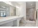 Accessible bathroom with double vanity and tiled walk-in shower at 16112 Lakeside Loop Ln, Cornelius, NC 28031