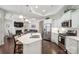 Open-concept kitchen with stainless steel appliances and island, connecting to a cozy living area at 16112 Lakeside Loop Ln, Cornelius, NC 28031
