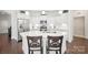 Modern kitchen with white cabinetry, stainless steel appliances, and quartz countertops at 16112 Lakeside Loop Ln, Cornelius, NC 28031