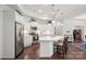 Bright kitchen featuring stainless steel appliances, white cabinetry, and quartz countertops at 16112 Lakeside Loop Ln, Cornelius, NC 28031