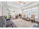 Bright, open-concept living space with hardwood floors seamlessly flows into a modern kitchen at 16112 Lakeside Loop Ln, Cornelius, NC 28031